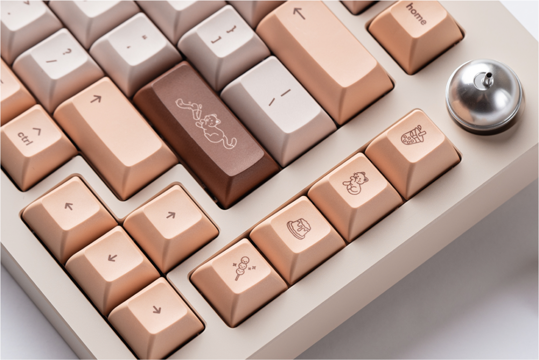 a close-up shot of the right side of Sprout 75. the enter key depicts a cat spilling boba. in the macro column, you can see novelties depicting cats and desserts.