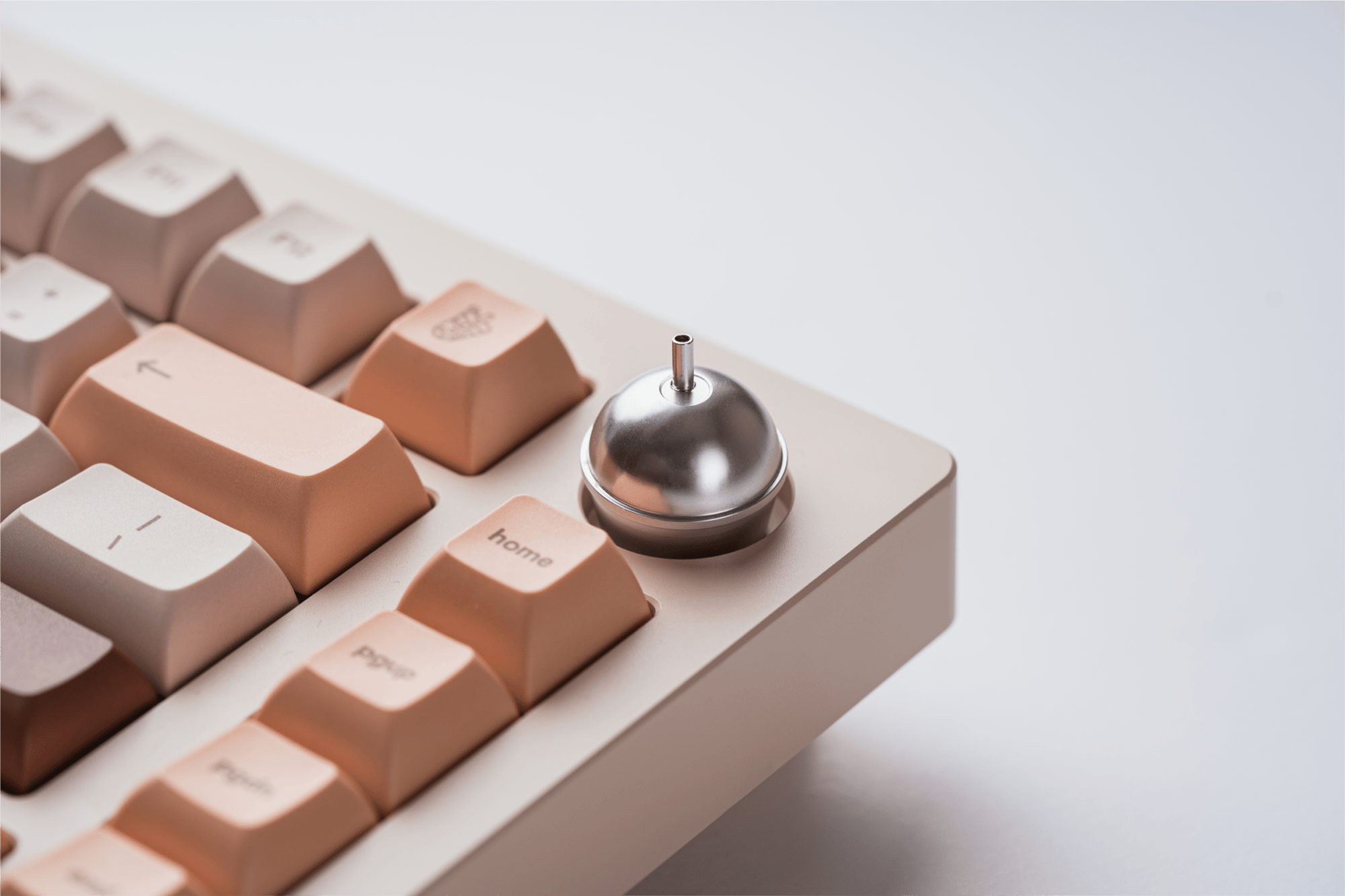 a close-up shot of the top right corner of Sprout 75. the silver knob is in focus, in the shape of a bubble tea cup with a straw sticking out of the top.